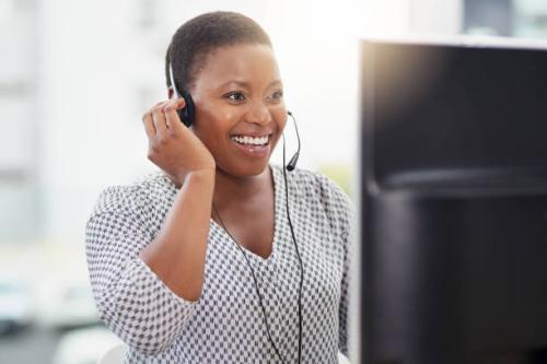 Shot of a call centre agent working on a computer in an office